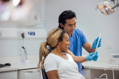 Dental Assistant School Student looking at x-rays with patient